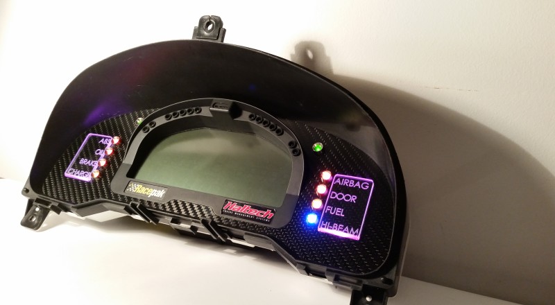 A Custom Cluster with a Racepak IQ3 Display built for a Nissan S15 Sivia 200sx with Pink LED illumination Side 2