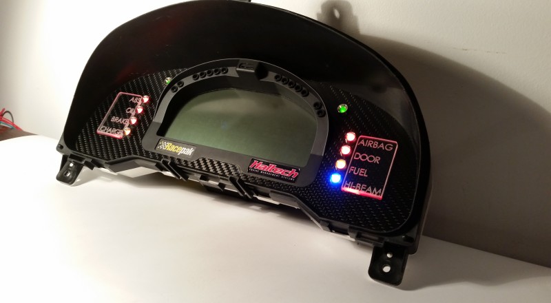 A Custom Cluster with a Racepak IQ3 Display built for a Nissan S15 Sivia 200sx with Red LED illumination Side 2