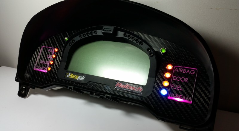 A Custom Cluster with a Racepak IQ3 Display built for a Nissan S15 Sivia 200sx with Pink LED illumination Side