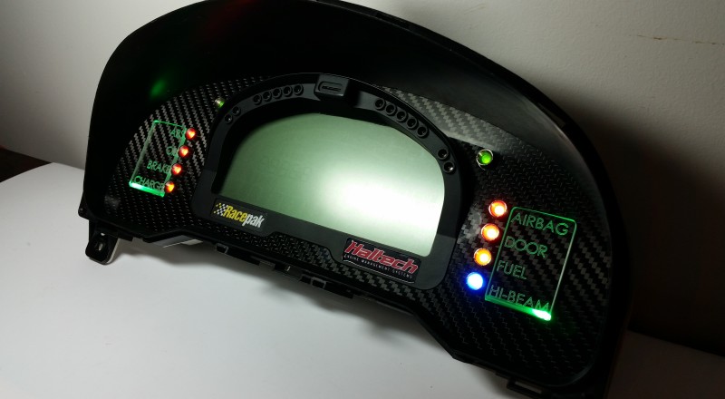 A Custom Cluster with a Racepak IQ3 Display built for a Nissan S15 Sivia 200sx with Green LED illumination Side