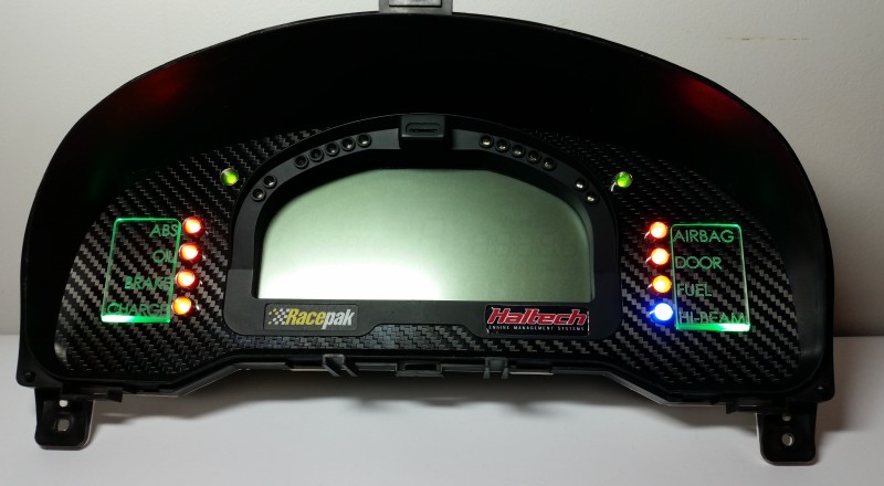 A Custom Cluster with a Racepak IQ3 Display built for a Nissan S15 Sivia 200sx with Green LED illumination Front