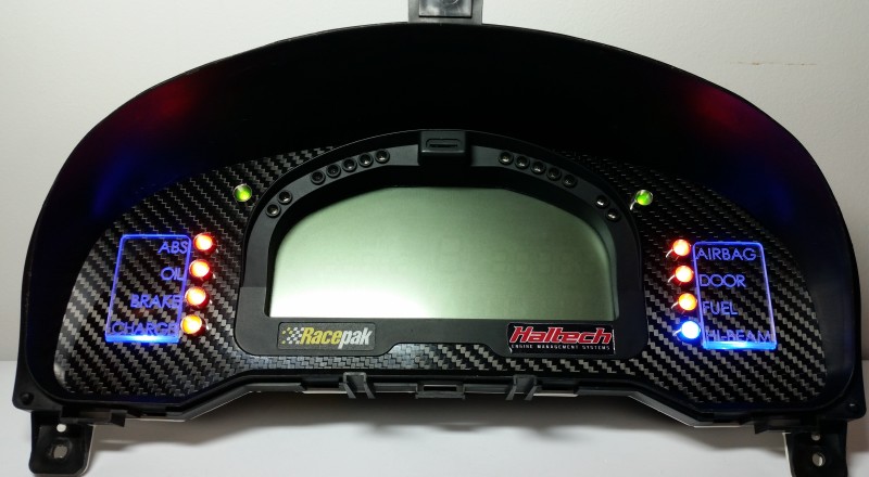 A Custom Cluster with a Racepak IQ3 Display built for a Nissan S15 Sivia 200sx with Blue LED illumination Front