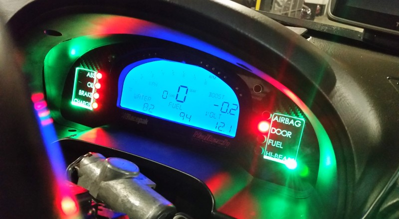 A Custom Cluster with a Racepak IQ3 Display installed in a Nissan S15 Sivia 200sx with Green LED illumination