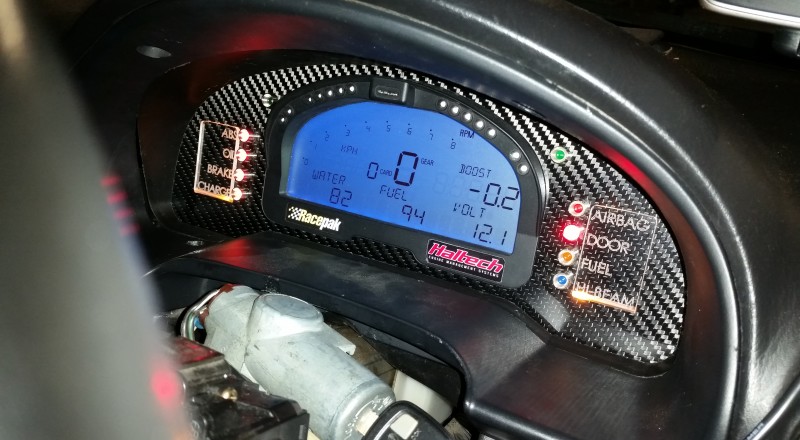 A Custom Cluster with a Racepak IQ3 Display installed in a Nissan S15 Sivia 200sx with Amber LED illumination with flash