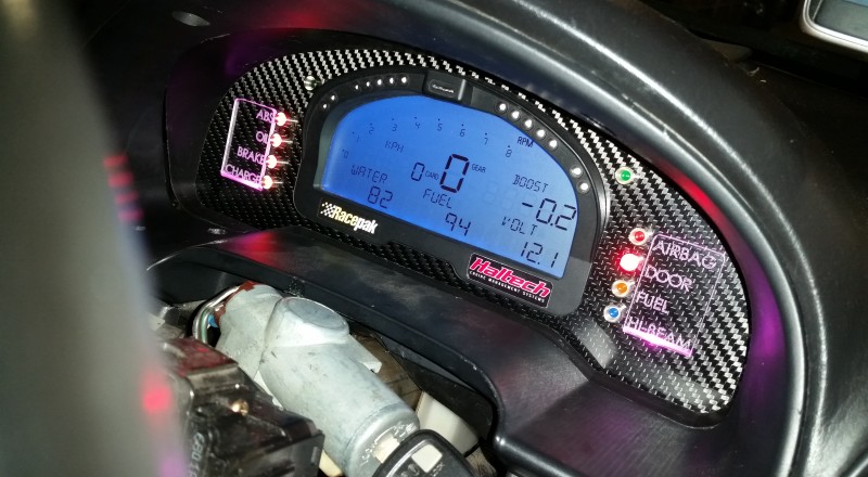 A Custom Cluster with a Racepak IQ3 Display installed in a Nissan S15 Sivia 200sx with Pink LED illumination with flash
