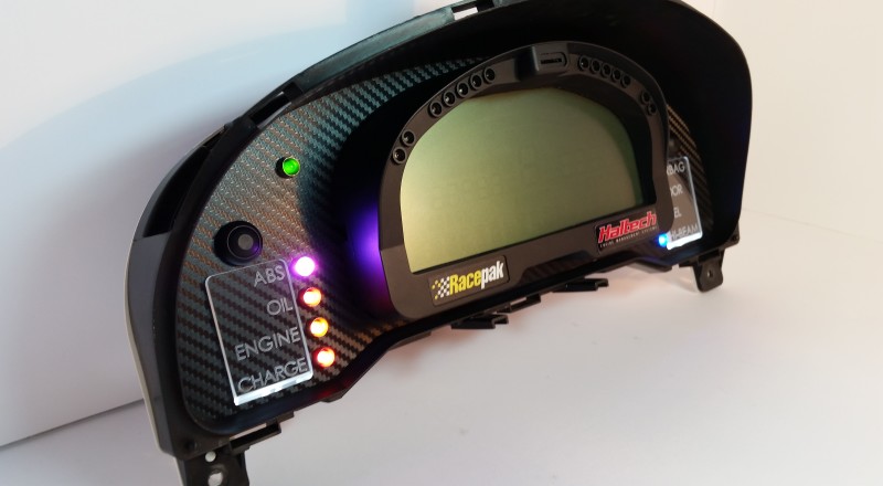 A Custom Cluster with a Racepak IQ3 Display built for a nissan S15 Sivia 200sx with White illumination Left